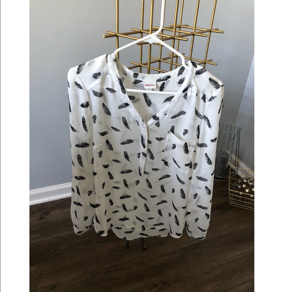 White blouse with black feather pattern.